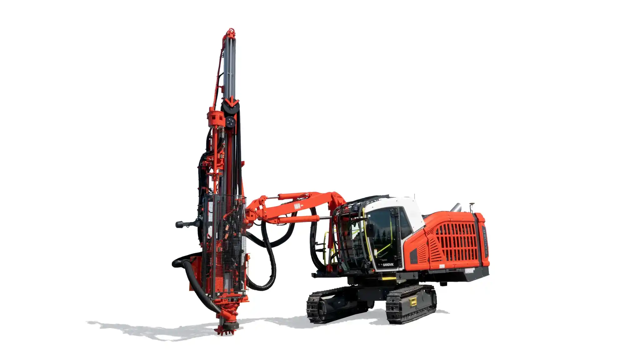 Sandvik Ranger DX surface top hammer drill rig shown in a mining or construction environment from a front-side angle. The yellow, self-propelled machine features a reinforced operator cabin, articulated drilling boom, and large rugged tires designed for precise and efficient surface drilling in quarrying and mining applications.