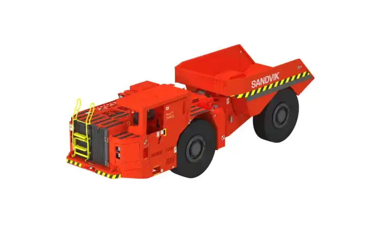 Sandvik underground mining haul truck shown in a mining environment from a side-front angle. The heavy-duty yellow vehicle features a reinforced chassis, large rugged tires, and an enclosed operator cabin, designed for safe and efficient transport of ore and material in underground mining operations