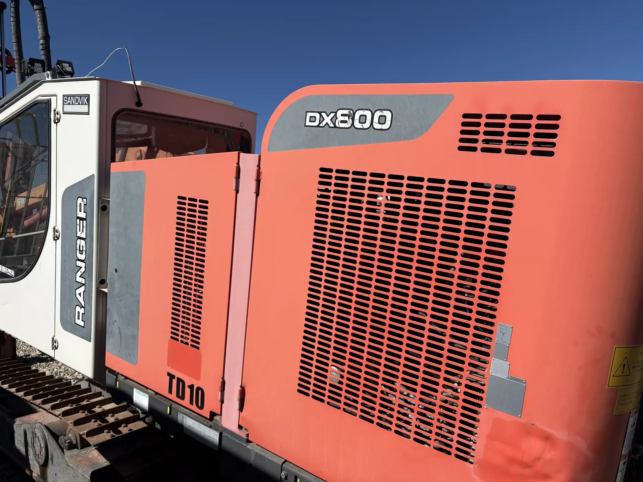 Sandvik Ranger™ DX800 surface drill rig operating on site, heavy-duty drilling equipment for mining and quarrying applications.